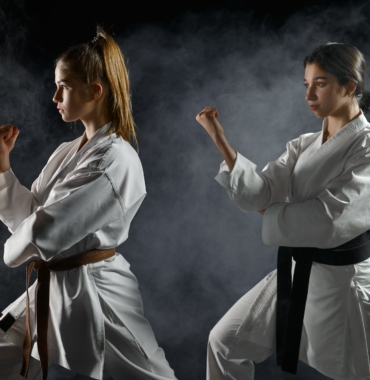 Female karatekas, training in white kimono