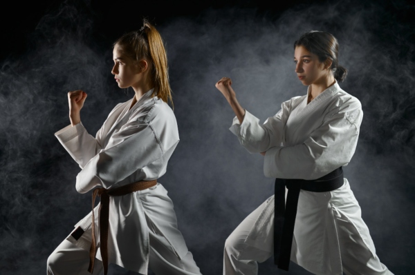 Female karatekas, training in white kimono