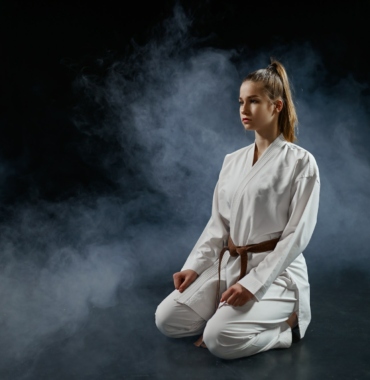 Female karatekas, training in white kimono