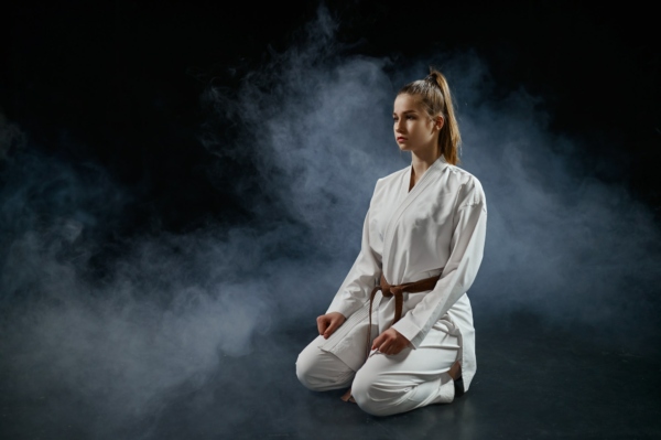 Female karatekas, training in white kimono